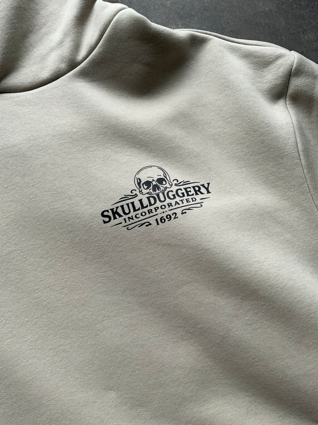 Skullduggery Certified Unscrupulous Hoodie in Stone