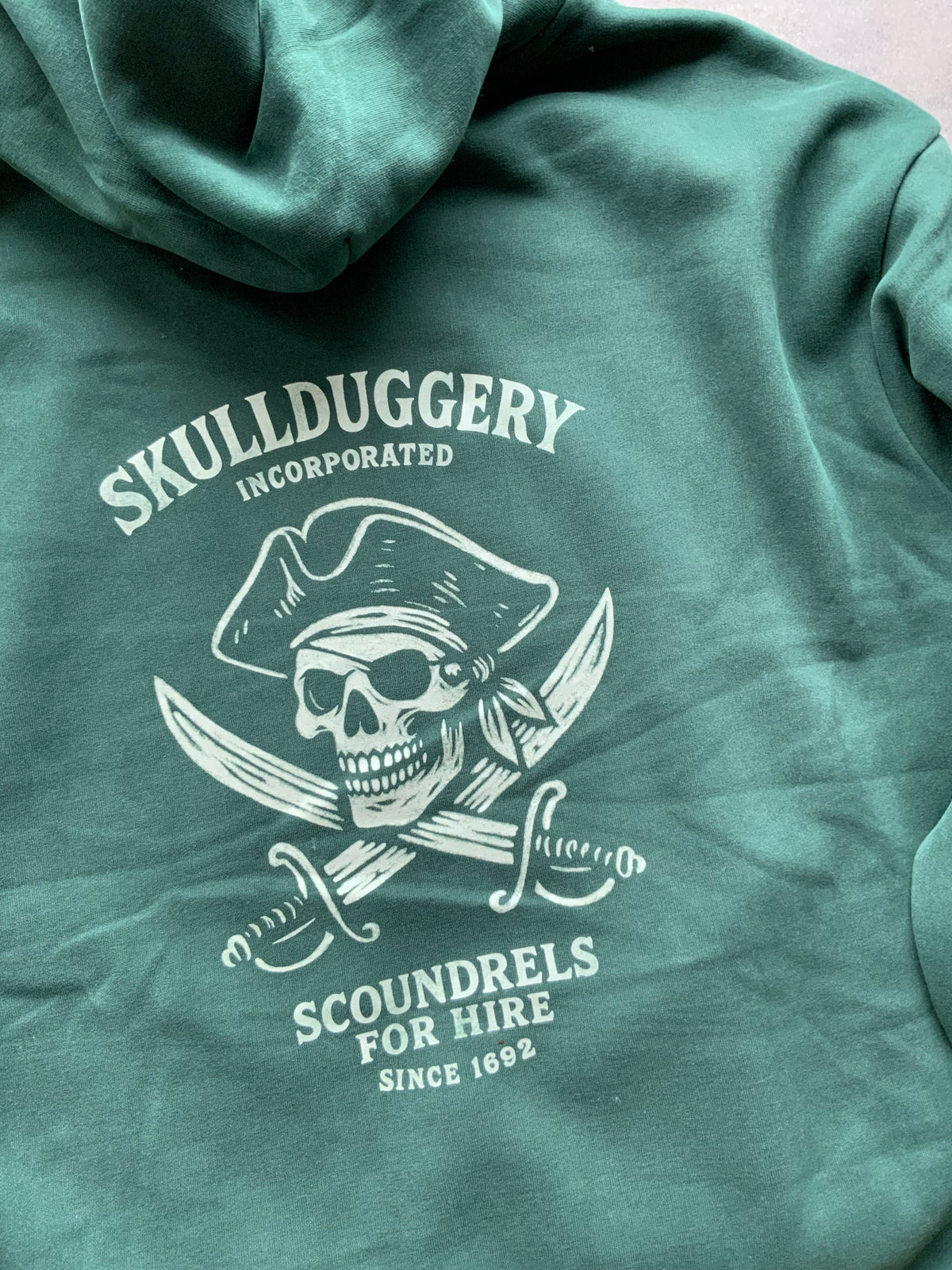Skullduggery Scoundrels Hoodie in bottle green